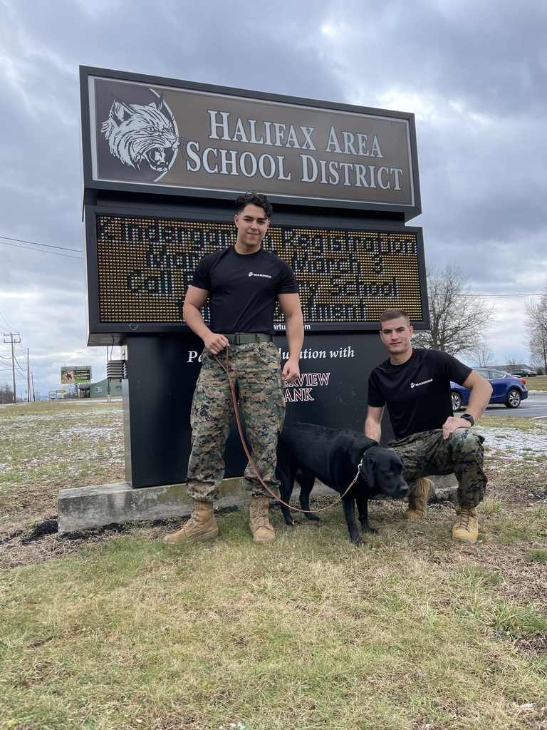 Abby with Marines in front of Halifax School District Sign